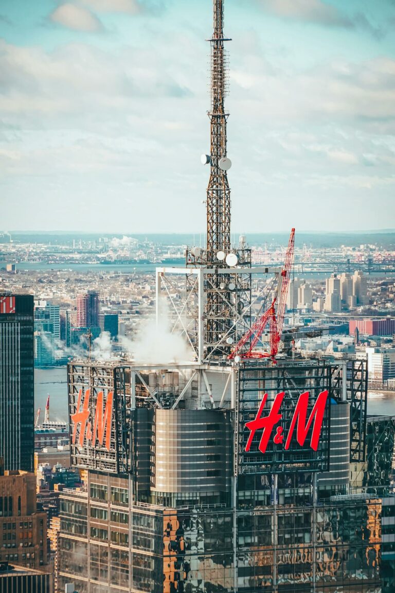 A stunning aerial shot of a New York City skyscraper featuring prominent H&M branding against the cityscape backdrop.
